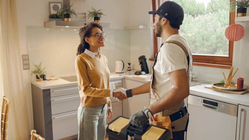 a homeowner shaking hands with a handyman