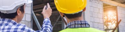 Two engineers inspecting a building