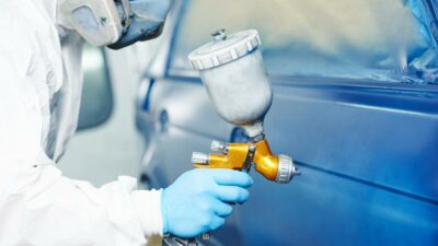 man painting a car