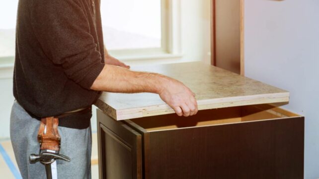 Contractor installing a new laminate kitchen counter top