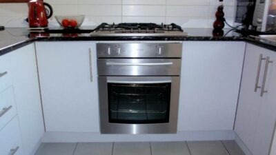 A practical kitchen features a built-in oven - cost to install an oven and stovetop, maximising space and functionality.